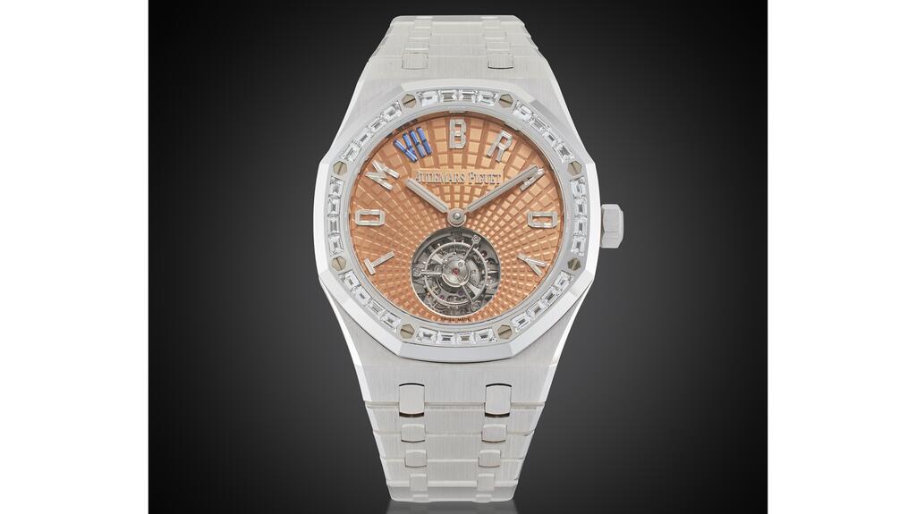 Tom Brady’s custom-made Audemars Piguet Royal Oak flying tourbillon has a salmon-colored dial in the brand’s “evolutive tapisserie” pattern, with Brady’s name spelled out in diamonds. (Image courtesy of Sotheby’s) Tom Brady Audermars Piguet from Netflix roast